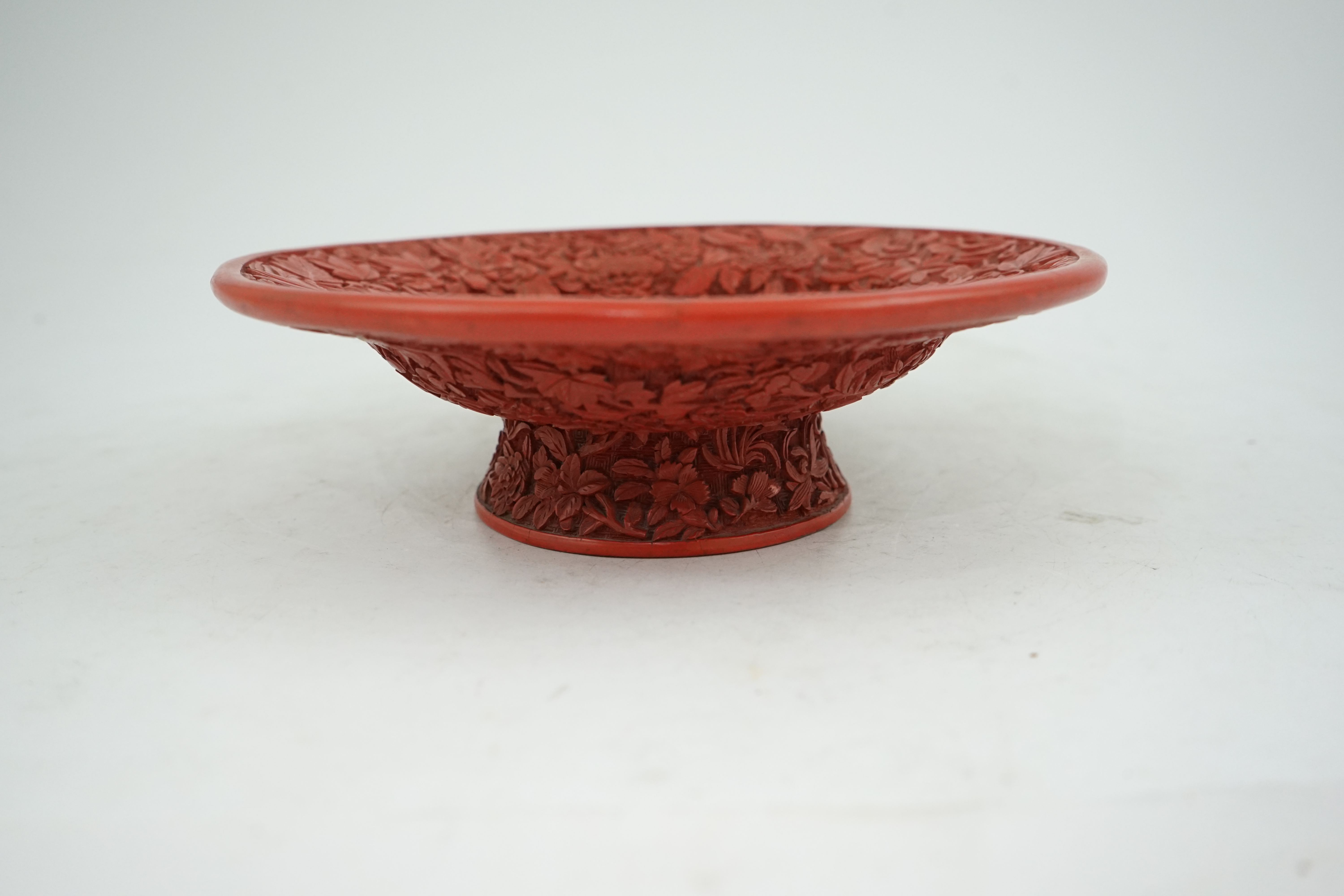 An unusual Chinese cinnabar lacquer ‘thousand flower’ footed dish, 18th/19th century